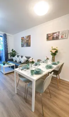 a dining room with a white table and chairs at New Apartment Prague 5 in Prague