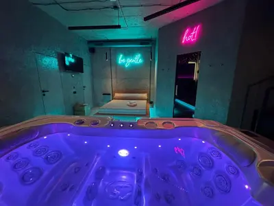 a jacuzzi tub in a room with a bed at SPA SPA Smíchov - Graff in Prague