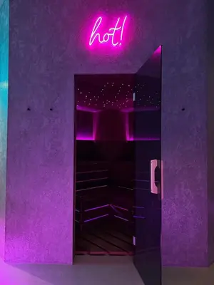 a purple room with a neon sign that says hot at SPA SPA Smíchov - Graff in Prague