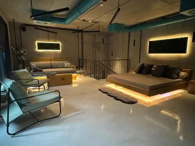a living room with a bed and a couch and chairs at SPA SPA Smíchov - Graff in Prague