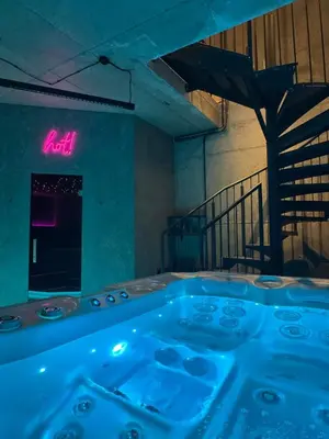 a hot tub in a room with a neon sign at SPA SPA Smíchov - Graff in Prague