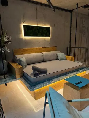 a bedroom with a bed in a room with a table at SPA SPA Smíchov - Graff in Prague