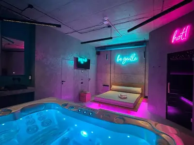 a bathroom with a hot tub with neon lights at SPA SPA Smíchov - Graff in Prague