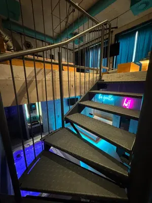 an empty stairs in a building with neon lights at SPA SPA Smíchov - Graff in Prague