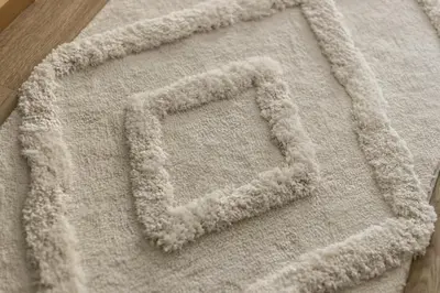 a white rug with a letter c on it at Prague Jungle Studio in Prague