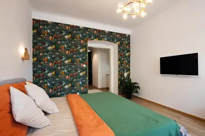 a bedroom with a bed and a chandelier at Prague Jungle Studio in Prague
