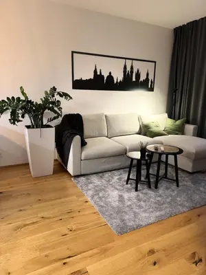 a living room with a couch and a table at Prague Bohemian Grey in Prague