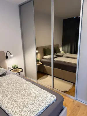 a bedroom with two beds and a mirror at Prague Bohemian Grey in Prague