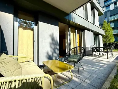 a patio with a couch and a table and chairs at Garden Residence Terrace Apartment in Prague