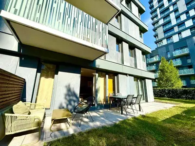 a patio with chairs and a table in front of a building at Garden Residence Terrace Apartment in Prague