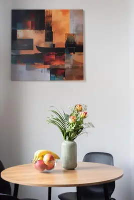a table with a vase of flowers and a bowl of fruit at Spacious loft-aparts on Karlin in Prague