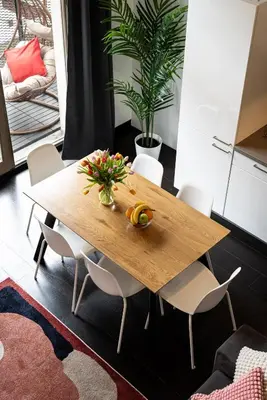 a wooden table in a room with white chairs at Spacious loft-aparts on Karlin in Prague