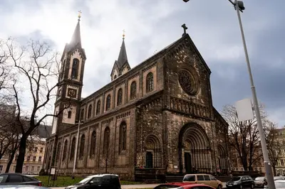 an old church with a clock tower on a street at Spacious loft-aparts on Karlin in Prague