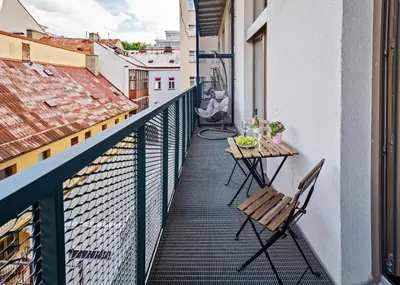 a balcony with a table and chairs on a building at Spacious loft-aparts on Karlin in Prague