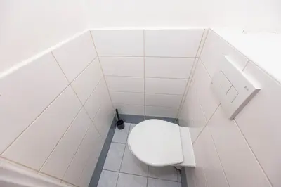 a bathroom with a white toilet in a stall at Apartment Velehradska in Prague