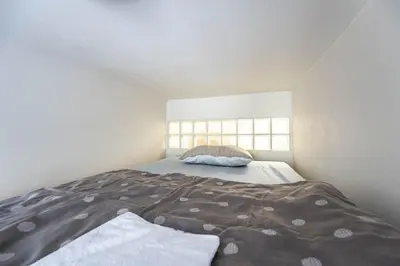 a bedroom with a bed with a pillow and a window at Apartment Velehradska in Prague