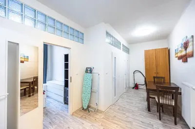 a room with a table and a dining room at Apartment Velehradska in Prague