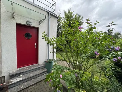 a red door on the side of a house at Prague Cozy Hideaway in Lysolaje