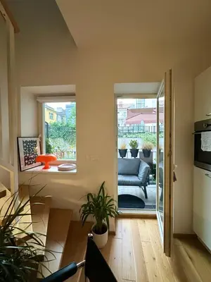 a living room with a couch and a window at Modern two-storey apartment with terrace in Prague