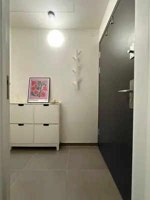 a room with a white dresser and a black door at Modern two-storey apartment with terrace in Prague