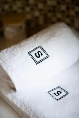 a close up of a white towel with the om at Residence Sodomov