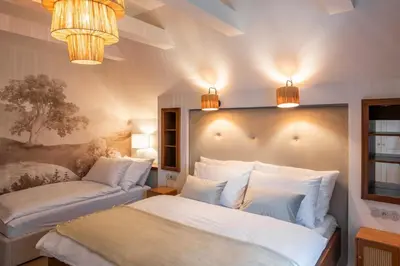 a bedroom with a bed and a couch and lights at Residence Sodomov