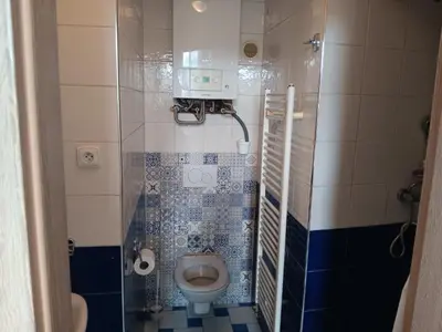 a small bathroom with a toilet in a stall at Cosy appartment close to main train station and city center in Prague