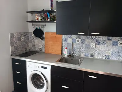 a kitchen with a washing machine and a sink at Cosy appartment close to main train station and city center in Prague