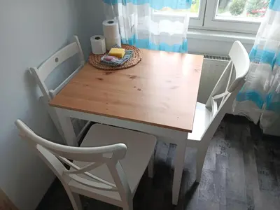 a dining room table with two chairs and a table at Cosy appartment close to main train station and city center in Prague