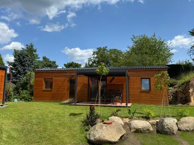 a small room with two beds and a window at Domky Slapy pod golfem in Slapy