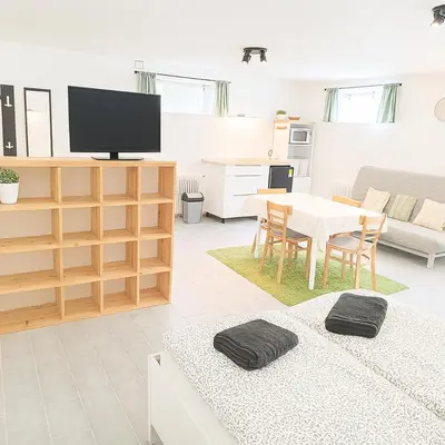 a living room with two beds and a table at Ubytování na faře in Prague