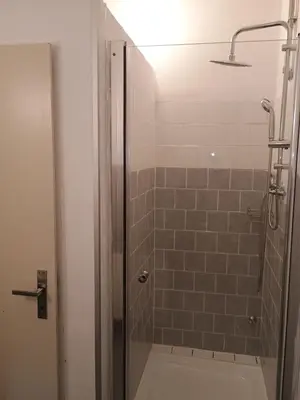 a shower with a glass door in a bathroom at Ubytování na faře in Prague