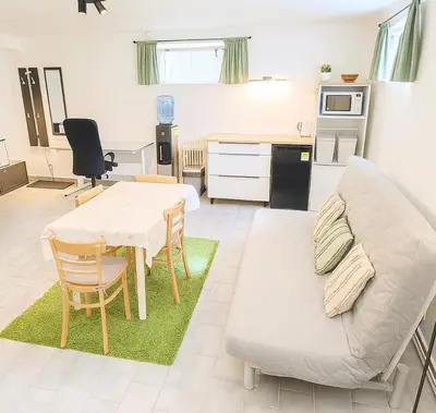 a living room with a table and a couch at Ubytování na faře in Prague
