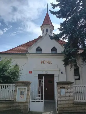 a church with a steeple on top of a building at Ubytování na faře in Prague