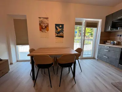 a dining room with a wooden table and chairs at Prague Airport Family Lodging in Tuchoměřice