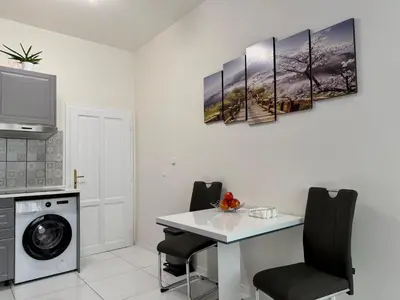 a kitchen with a table and a washing machine at PRAGUE's Hidden Pearl - center in Prague