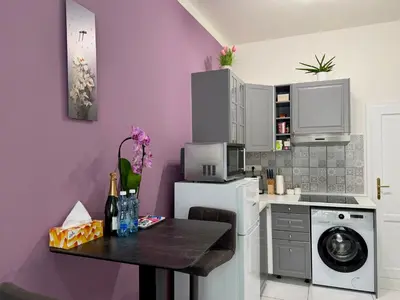 a kitchen with a table and a washing machine at PRAGUE's Hidden Pearl - center in Prague
