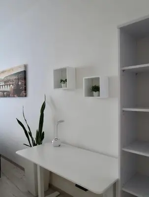 a white desk in a room with shelves at PRAGUE's Hidden Pearl - center in Prague