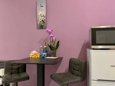 a small table with chairs and a tv on a wall at PRAGUE's Hidden Pearl - center in Prague