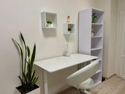 a white desk in a room with a plant at PRAGUE's Hidden Pearl - center in Prague