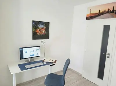 a desk with a computer and a chair in a room at Karlin Executive - Standing Desk, Monitor & Garage in Prague