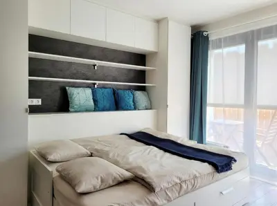 a bedroom with a bed and a large window at Karlin Executive - Standing Desk, Monitor & Garage in Prague