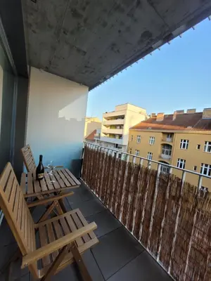 a balcony with a table and chairs on a balcony at Karlin Executive - Standing Desk, Monitor & Garage in Prague