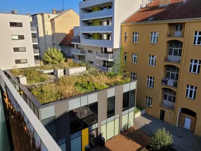 an apartment building with plants on the roof at Karlin Executive - Standing Desk, Monitor & Garage in Prague