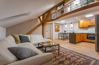a living room with a couch and a table at Parkview Penthouse in Prague