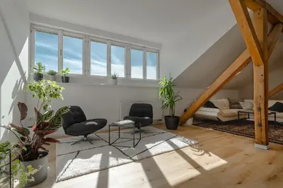 a living room with two chairs and a couch at Parkview Penthouse in Prague