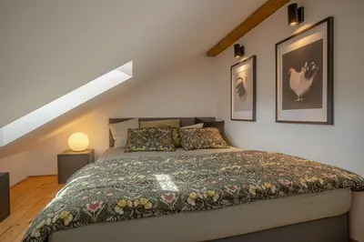 a bedroom with a large bed in a attic at Parkview Penthouse in Prague