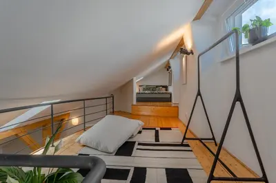 a room with a staircase with a pillow on the floor at Parkview Penthouse in Prague