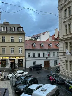 a group of cars parked in a parking lot next to buildings at Cozy Prague Apartment in Prague