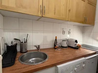 a kitchen counter top with a sink and a counter top at Cozy Prague Apartment in Prague